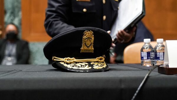 The hat of acting U.S. Capitol Police chief Yogananda Pittman sits on the table before an Appropriations Subcommittee hearing on Capitol Hill on April 21, 2021 in Washington, DC. The committee is hearing testimony on the FY 2022 budget request for the Architect of the Capitol, Senate Sergeant of Arms and the U.S. Capitol Police.  - Sputnik International