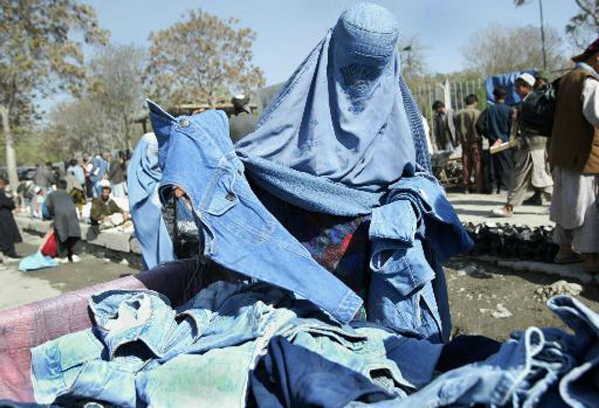 Афганская женщина выбирает голубые джинсы на улице Кабула, Афганистан, 2003 год - Sputnik International, 1920, 23.12.2022