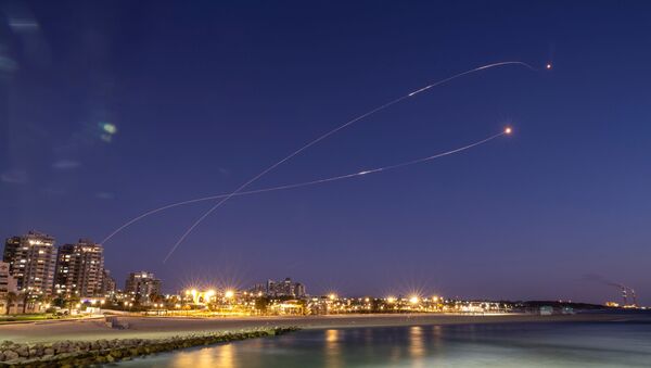 Streaks of light are seen as Israel's Iron Dome anti-missile system intercept rockets launched from the Gaza Strip towards Israel, as seen from Ashkelon May 19, 2021 - Sputnik International