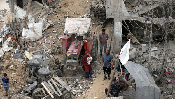 Palestinians return to their houses which were destroyed by Israeli strikes in the recent cross-border violence between Palestinian militants and Israel, following Israel-Hamas truce, in Gaza May 21, 2021 - Sputnik International