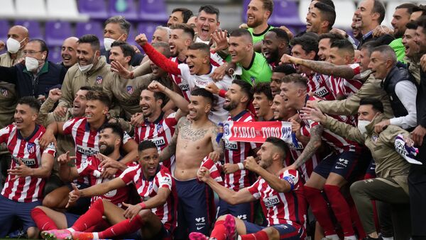 Atletico Madrid players celebrate at the end of the Spanish La Liga soccer match between Atletico Madrid and Valladolid at the Jose Zorrilla stadium in Valladolid, Spain, Saturday, May 22, 2021. Atletico won 2-1 and clinches its 11th Spanish La Liga title. - Sputnik International
