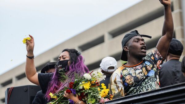 Tony B reacts while rapping from a truck as people march during the One Year, What's Changed? rally hosted by the George Floyd Global Memorial to commemorate the first anniversary of his death, in Minneapolis, Minnesota, U.S. May 23, 2021 - Sputnik International