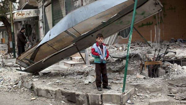 In this Monday, Feb. 27, 2012 file photo, a boy stands in from of a shop destroyed in Syrian Army shelling in the center of Idlib, in northern Syria. - Sputnik International