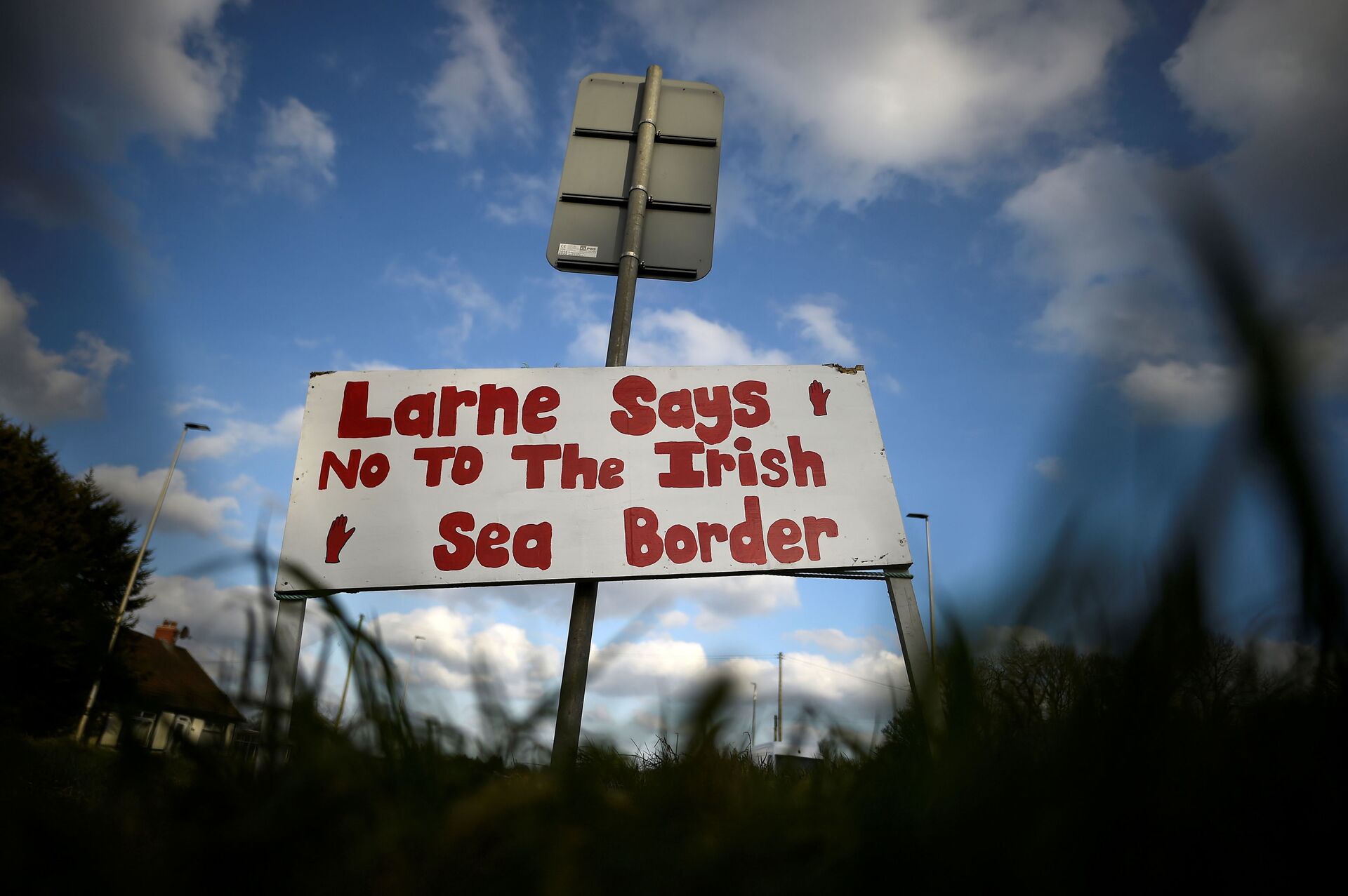 A sign is seen with a message against the Brexit border checks in relation to the Northern Ireland protocol near the harbour in Larne, Northern Ireland. February 12, 2021 - Sputnik International, 1920, 22.09.2021