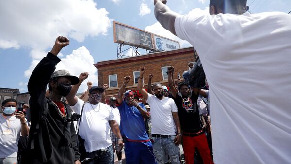 People chant in solidarity with George Floyd while showing raised fists on the first anniversary of his death, at George Floyd Square, in Minneapolis, Minnesota, U.S., May 25, 2021.  - Sputnik International