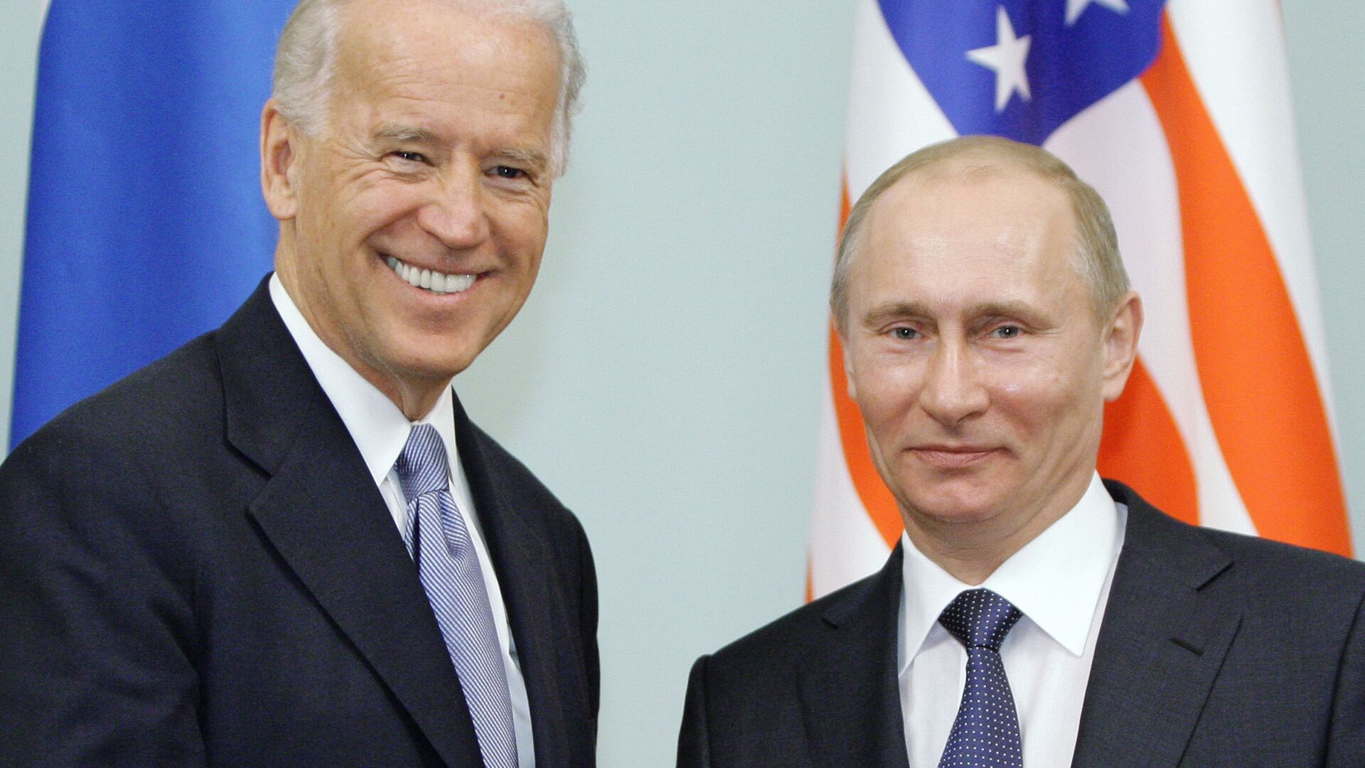 In this March 10, 2011 file photo, then Vice President  Joe Biden, left, shakes hands with Russian Prime Minister Vladimir Putin in Moscow, Russia. - Sputnik International, 1920, 07.06.2021