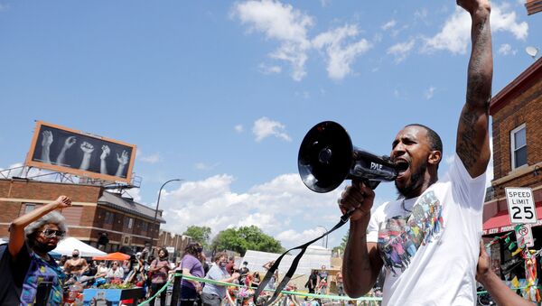 Community organizer Tommy McBrayer leads a chant in solidarity with George Floyd on the first anniversary of his death, at George Floyd Square, in Minneapolis, Minnesota, U.S., May 25, 2021. - Sputnik International