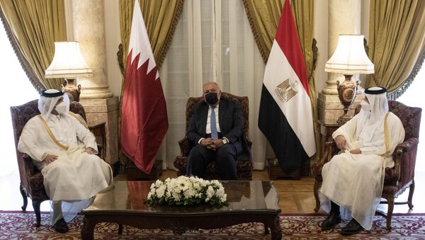 Qatar's Deputy Prime Minister and Foreign Minister Sheikh Mohammed bin Abdulrahman bin Jassim Al-Thani, left, meets with Egyptian Foreign Minister Sameh Shoukry, center, at the Tahrir Palace in Cairo, Egypt, Tuesday, May 25, 2021 - Sputnik International