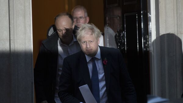 British Prime Minister Boris Johnson and his advisor Dominic Cummings, left, leave 10 Downing Street in London, and get in a car together to go to the Houses of Parliament, Monday, Oct. 28, 2019 - Sputnik International