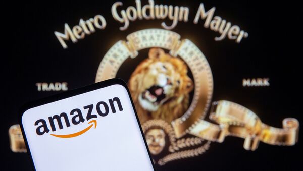 Smartphone with Amazon logo is seen in front of displayed MGM logo in this illustration taken, May 26, 2021 - Sputnik International
