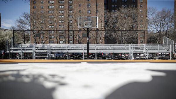 Basketball backboards stand without hoops after city officials had them removed to reduce gatherings at Holcombe Rucker Park, Thursday, March 26, 2020, in New York. Across the U.S., police departments are taking a lead role in enforcing social distancing rules that health officials say are critical to containing the coronavirus. In New York City, they've started dismantling basketball hoops to prevent people from gathering in parks and playing.  - Sputnik International