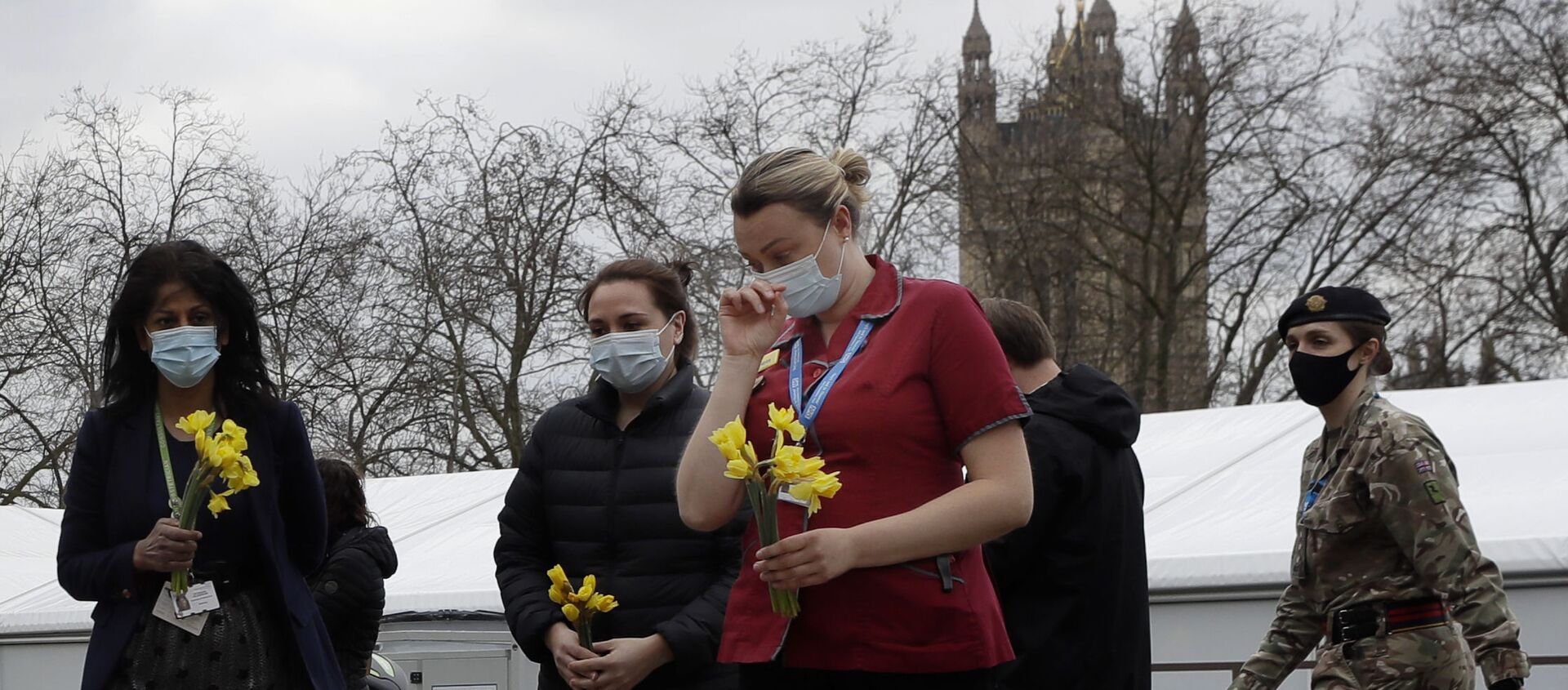Members of NHS staff lay flowers after a minute of silence and reflection at St Thomas' hospital in London, Tuesday, March 23, 2021 - Sputnik International, 1920