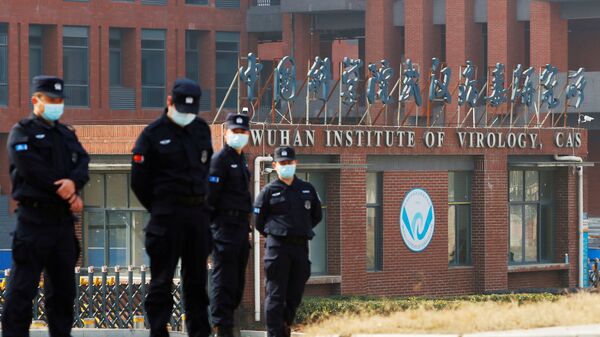 Security personnel keep watch outside the Wuhan Institute of Virology during a visit by the World Health Organisation (WHO) team tasked with investigating the origins of the coronavirus disease (COVID-19), in Wuhan, Hubei Province, China 3 February 2021. - Sputnik International