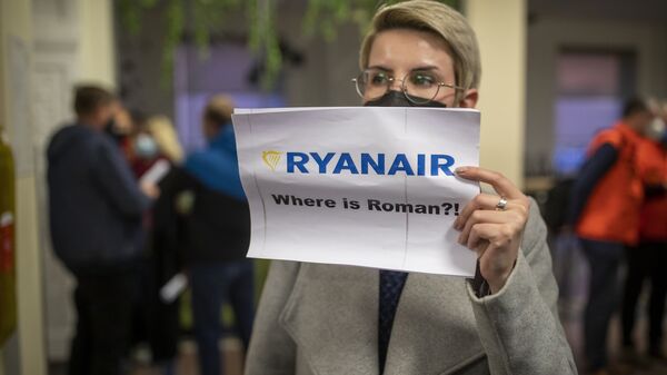 A woman holds a poster reads where is Raman Pratasevich?! as she waits to see passengers of the Ryanair plane with registration number SP-RSM, carrying opposition figure Raman Pratasevich which was traveling from Athens to Vilnius and was diverted to Minsk after a bomb threat, after its landing at the International Airport outside Vilnius, Lithuania, Sunday, May 23, 2021 - Sputnik International