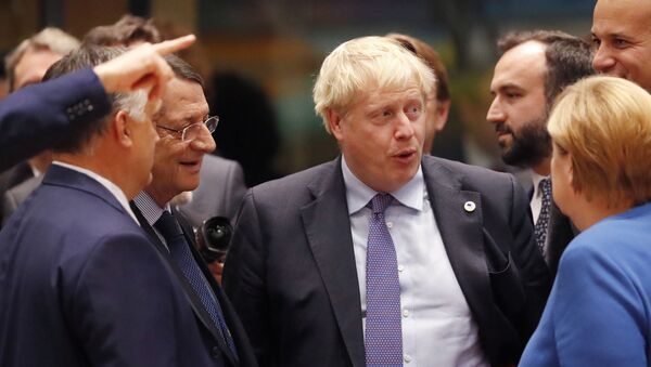 British Prime Minister Boris Johnson, center, speaks with Hungarian Prime Minister Viktor Orban, left, and German Chancellor Angela Merkel, right, during a round table meeting at an EU summit in Brussels, Thursday, Oct. 17, 2019. - Sputnik International