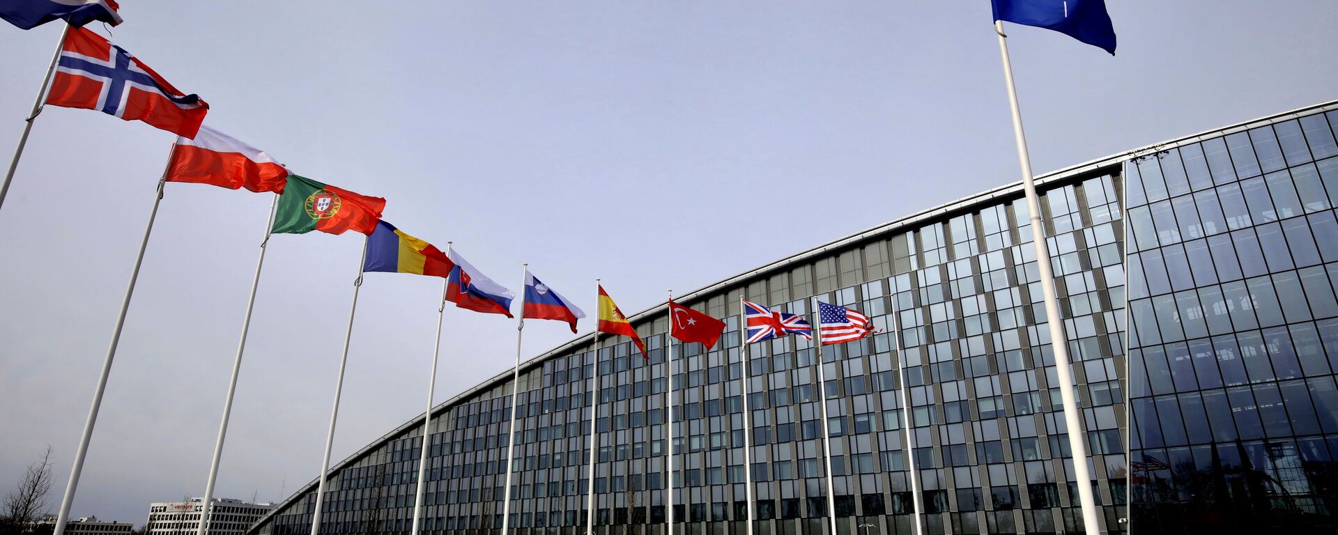 Flags of Alliance members flap in the wind outside NATO headquarters in Brussels, Friday, Feb. 28, 2020 - Sputnik International, 1920