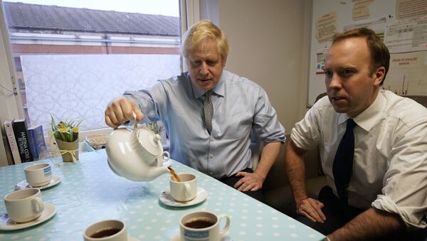 Secretary of State for Health and Social Care Matt Hancock, right, and Prime Minister Boris Johnson have tea with members of staff as they visit Bassetlaw District General Hospital, during their General Election campaign in Worksop, England, Friday, Nov. 22, 2019.  - Sputnik International