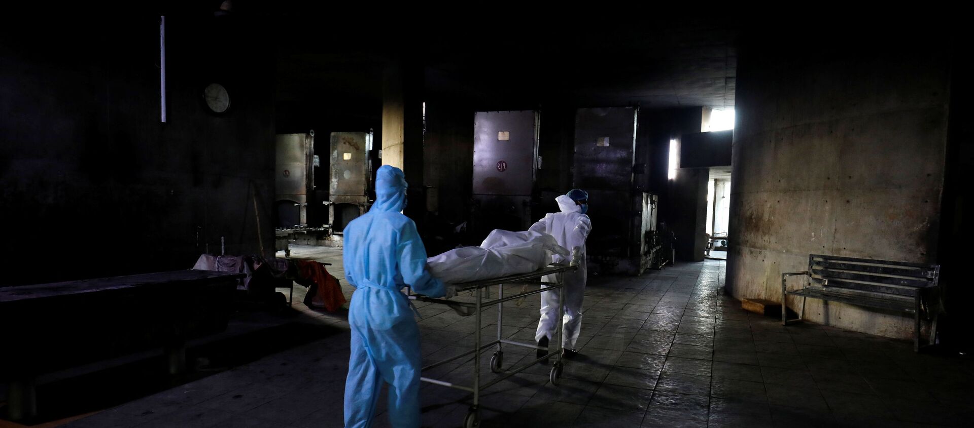 SENSITIVE MATERIAL. THIS IMAGE MAY OFFEND OR DISTURB    Workers move the body of a person who died from the coronavirus disease (COVID-19) for cremation inside the Kurukshetra crematorium in Surat, India, May 11, 2021. - Sputnik International, 1920