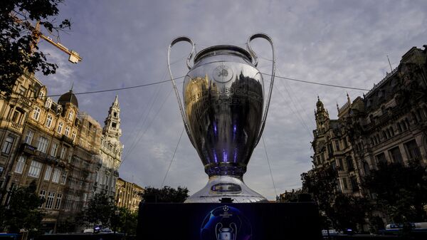 A giant replica of the UEFA Champions League trophy is displayed in Porto, Portugal, Thursday, May 27, 2021. Manchester City will play against Chelsea in the Champions League final on Saturday. - Sputnik International