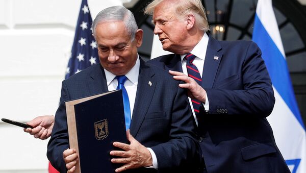 Israel's Prime Minister Benjamin Netanyahu stands with U.S. President Donald Trump after signing the Abraham Accords, normalizing relations between Israel and some of its Middle East neighbors,  in a strategic realignment of Middle Eastern countries against Iran, on the South Lawn of the White House in Washington, U.S., September 15, 2020. - Sputnik International