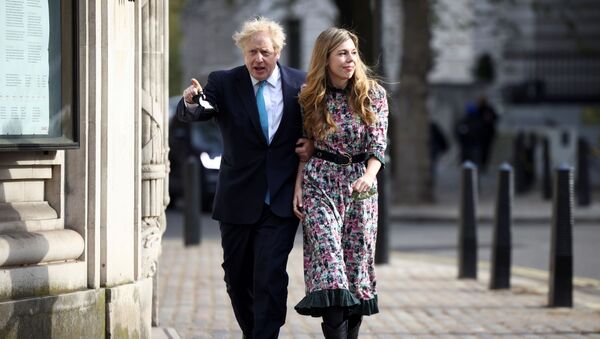 Britain's Prime Minister Boris Johnson and partner Carrie Symonds arrive at the Methodist Central Hall to vote, in London, Britain, 6 May 2021 - Sputnik International