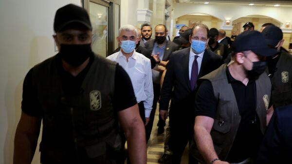 Palestinian Hamas Gaza Chief Yehya Al-Sinwar and head of the Egyptian general intelligence Abbas Kamel walk as they meet in Gaza on 31 May 2021.  - Sputnik International