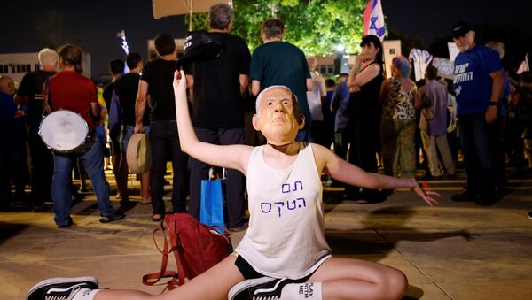 A protester wearing a mask of Prime Minister Benjamin Netanyahu and a t-shirt reading Ceremony is over gestures during a rally in support of a so-called government of change, a day after far-right party leader Naftali Bennett threw his crucial support behind a unity government in Israel to unseat Netanyahu, in Tel Aviv, Israel May 31, 2021 - Sputnik International