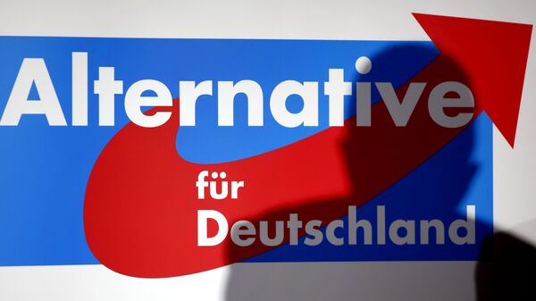 The shadow of the founder of the new German party 'Alternative fuer Deutschland' (Alternative for Germany), Bernd Lucke, is seen in on a logo during the party's founding convention in Berlin, Germany, Sunday, April 14, 2013 - Sputnik International