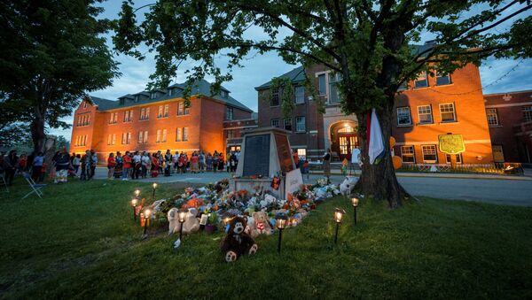Kamloops residents and First Nations people gather to listen to drummers and singers at a memorial in front of the former Kamloops Indian Residential School after the remains of 215 children, some as young as three years old, were found at the site last week, in Kamloops, British Columbia, Canada May 31, 2021 - Sputnik International