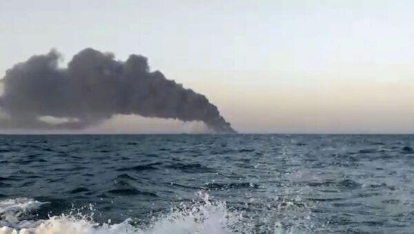 This image made from a video released on Wednesday, June 2, 2021 by Asriran.com, shows smoke rising from Iran's navy support ship Kharg in the Gulf of Oman - Sputnik International