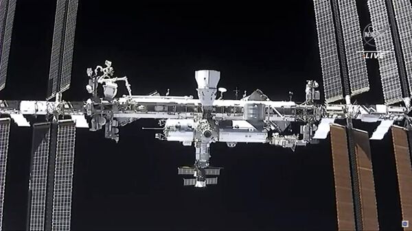 This image made from NASA TV shows the international space station, seen from the SpaceX Crew Dragon spacecraft Saturday, April 24, 2021 - Sputnik International