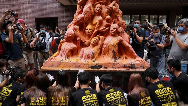 University students clean the Pillar of Shame statue at the University of Hong Kong on the 32nd anniversary of the crackdown on pro-democracy demonstrators at Beijing's Tiananmen Square in 1989, in Hong Kong, China June 4, 2021 - Sputnik International