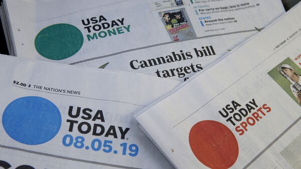 FILE - In this Aug. 5, 2019, file photo, sections of a USA Today newspaper rest together in Norwood, Mass. Gannett Co., Inc. reports earnings Thursday, Feb. 27. - Sputnik International
