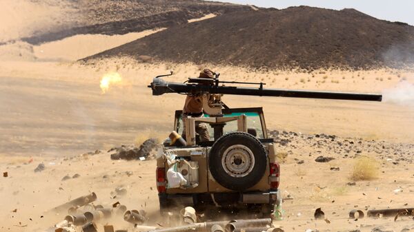 A Yemeni government fighter fires a vehicle-mounted weapon at a frontline position during fighting against Houthi fighters in Marib, Yemen March 9, 2021 - Sputnik International