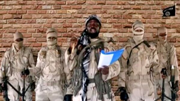 Boko Haram leader Abubakar Shekau speaks in front of guards in an unknown location in Nigeria in this still image taken from an undated video obtained on January 15, 2018. - Sputnik International