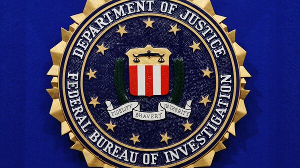 The Federal Bureau of Investigation (FBI) seal is seen on the lectern following a press conference announcing the FBI's 499th and 500th additions to the Ten Most Wanted Fugitives list on 17 June 2013 at the Newseum in Washington, DC.  - Sputnik International
