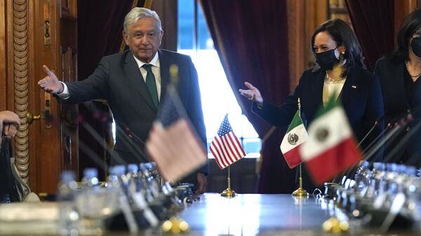 US Vice President Kamala Harris and Mexican President Andres Manuel Lopez Obrador gesture as they arrive for a bilateral meeting Tuesday, June 8, 2021, at the National Palace in Mexico City. - Sputnik International