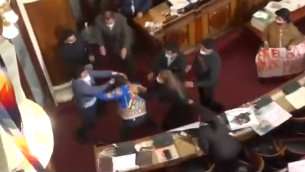 Bolivian lawmakers Antonio Colque (MAS) and Henry Montero (Creemos) trade punches during a tense hearing in Bolivia's Plurinational Legislative Assembly on June 8, 2021. - Sputnik International