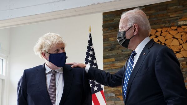 U.S. President Joe Biden speaks with Britain's Prime Minister Boris Johnson, as they look at historical documents and artefacts relating to the Atlantic Charter during their meeting, at Carbis Bay Hotel, Carbis Bay, Cornwall, Britain June 10, 2021  - Sputnik International