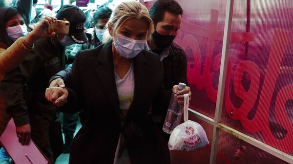 Bolivia's former interim President Jeanine Anez is escorted into a police station after giving her statement at the prosectors's office, in La Paz, Bolivia, Saturday, March 13, 2021. - Sputnik International