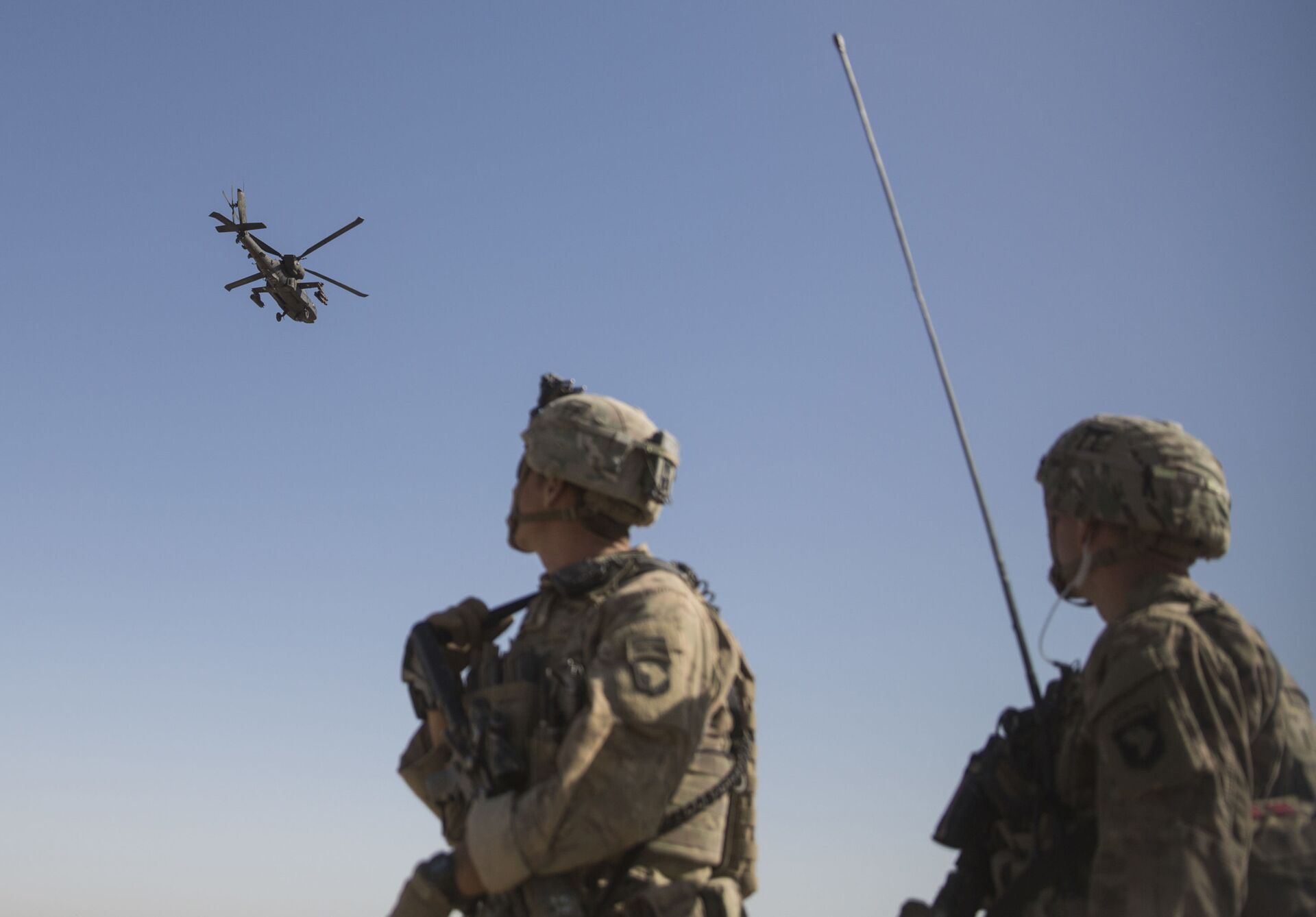 This June 10, 2017 photo released by the U.S. Marine Corps shows an AH-64 Apache attack helicopter provides security from above while CH-47 Chinooks drop off supplies to U.S. Soldiers with Task Force Iron at Bost Airfield, Afghanistan. - Sputnik International, 1920, 07.09.2021