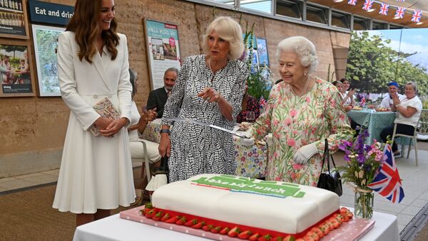 Britain's Queen Elizabeth holds a sword in order to cut a cake next to Catherine, the Duchess of Cambridge and Camilla,  Duchess of Cornwall - Sputnik International