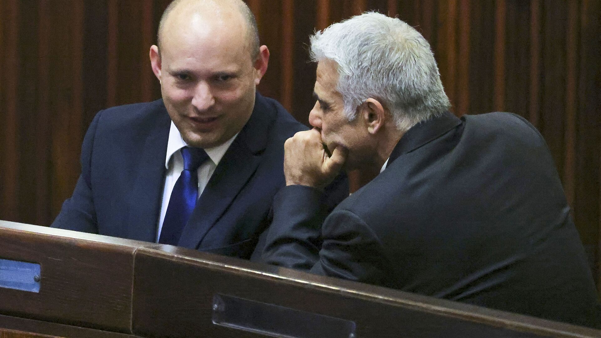 Naftali Bennett (L), smiles as he speaks to Yesh Atid party leader, Yair Lapid, during a special session of the Knesset, Israel's parliament, to elect a new president, in Jerusalem on June 2, 2021. - Sputnik International, 1920, 17.06.2021