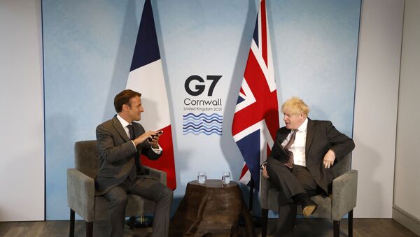 Britain's Prime Minister Boris Johnson and France's President Emmanuel Macron take part in a bilateral meeting during the G7 summit in Carbis bay, Cornwall on June 12, 2021.  - Sputnik International