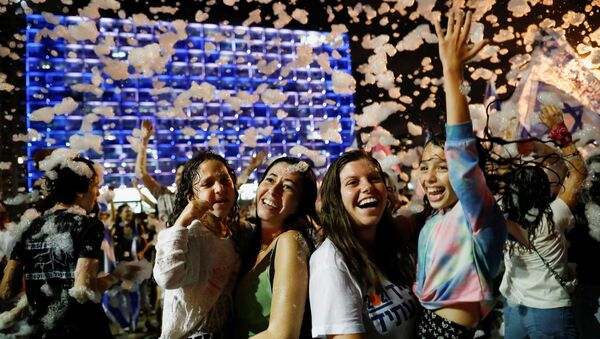 People celebrate after Israel's parliament voted in a new coalition government, ending Benjamin Netanyahu's 12-year hold on power, at Rabin Square in Tel Aviv, Israel June 13, 2021. - Sputnik International