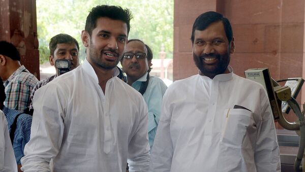 Newly elected Indian Minister of Consumer Affairs, Food and Public Distribution, Ramvilas Paswan (R) and his son, newly elected Member of Parliament (MP) Chirag Paswan arrive for the first session of India's newly elected parliament in New Delhi on June 4, 2014. - Sputnik International