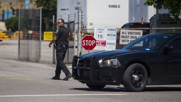 A police officer walks at the entrance to a Mueller Co. fire hydrant plant where police said multiple people were shot to death and others were wounded in Albertville, Ala., on Tuesday, June 15, 2021 - Sputnik International