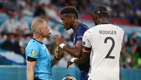 Soccer Football - Euro 2020 - Group F - France v Germany - Football Arena Munich, Munich, Germany - June 15, 2021 France's Paul Pogba remonstrates with the assistant referee as Germany's Antonio Rudiger looks on - Sputnik International
