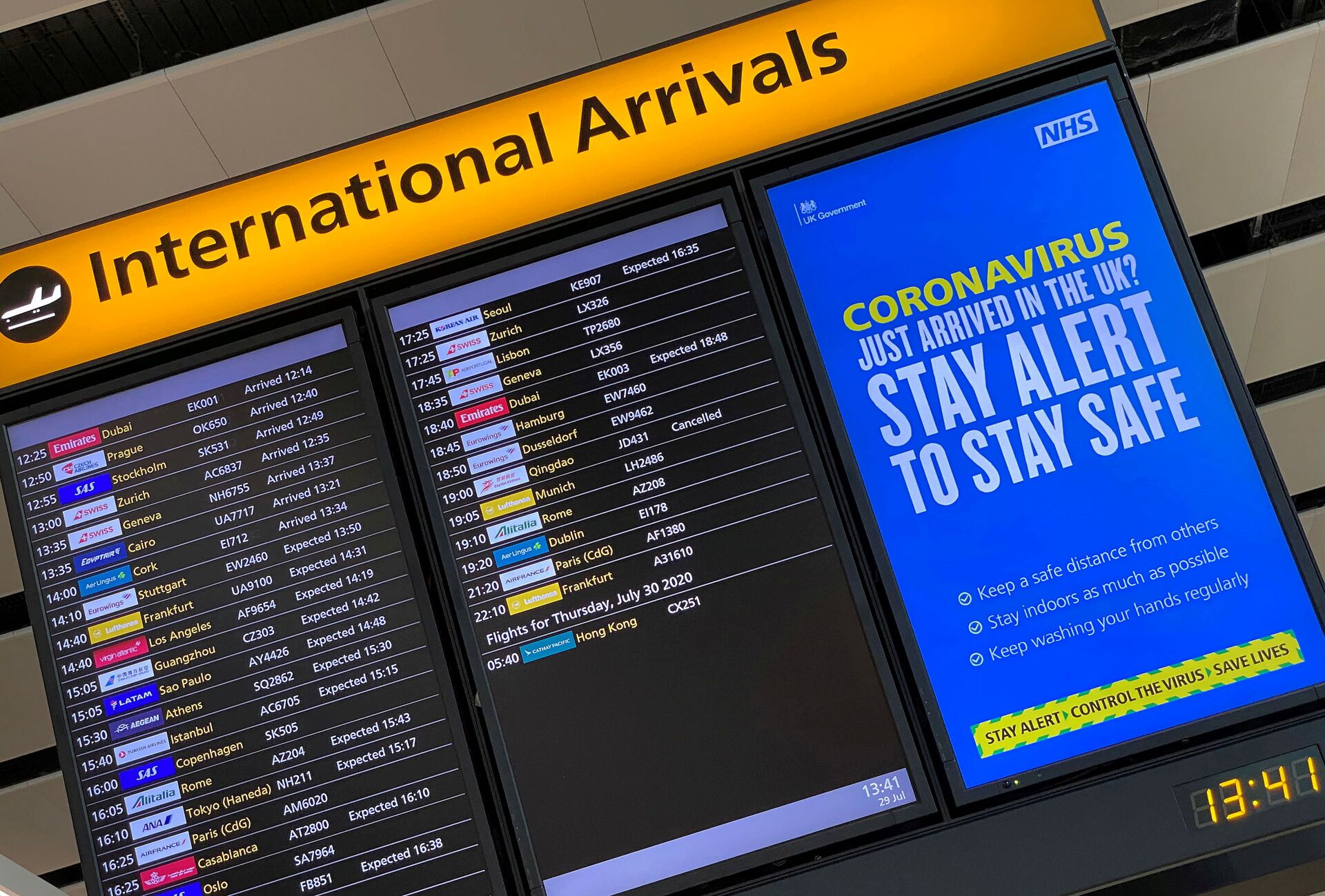 A public health campaign message is displayed on an arrivals information board at Heathrow Airport, following the outbreak of the coronavirus disease (COVID-19), London, Britain, July 29, 2020 - Sputnik International, 1920, 07.09.2021