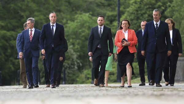 DUP leader Edwin Poots (far right) and the new First Minister Paul Givan (second from left) arrive at Stormont - Sputnik International
